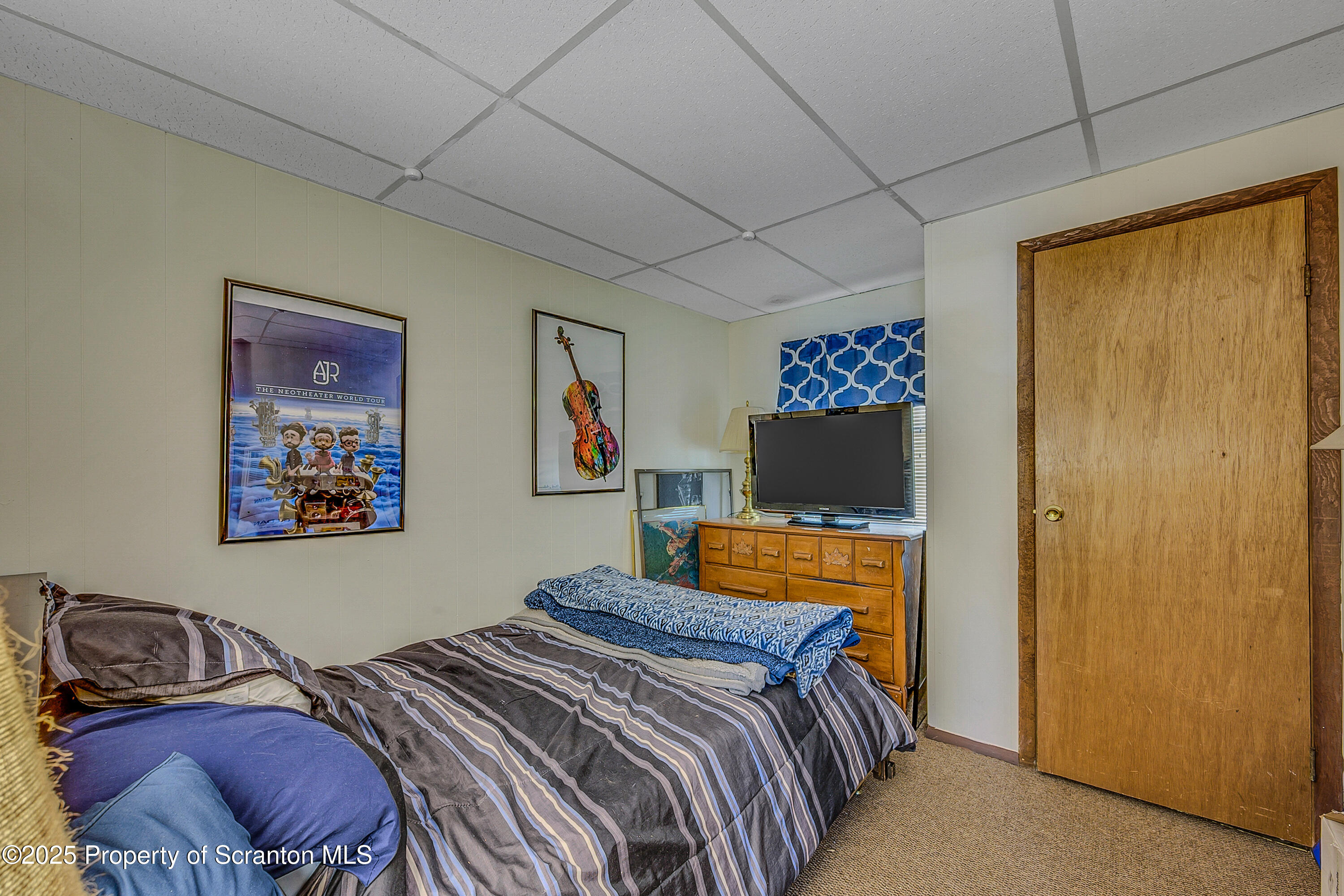 106 Lookout Drive Hawley, PA 18428 - Photo 20 of 43 a bedroom with a bed and a painting on the wall