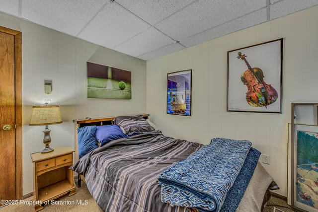 a bedroom with bed and painting on the wall