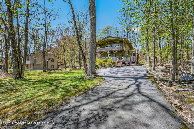 a view of a yard with a house in the background