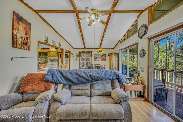 a living room with furniture a couch and a floor to ceiling window