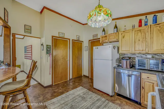 a kitchen with stainless steel appliances granite countertop a refrigerator a microwave oven a sink and dishwasher