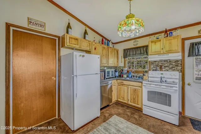 a kitchen with a refrigerator and a stove
