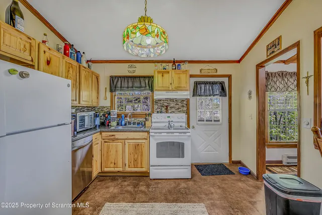 a kitchen with stainless steel appliances granite countertop a refrigerator and a stove