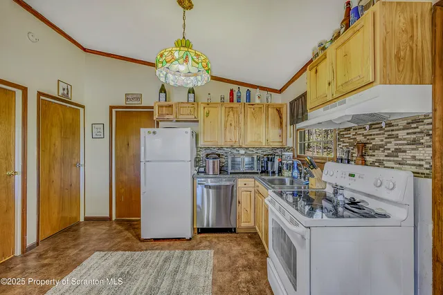 a kitchen with stainless steel appliances granite countertop a stove and refrigerator