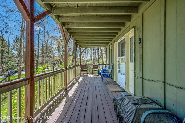 a view of a balcony with wooden floor