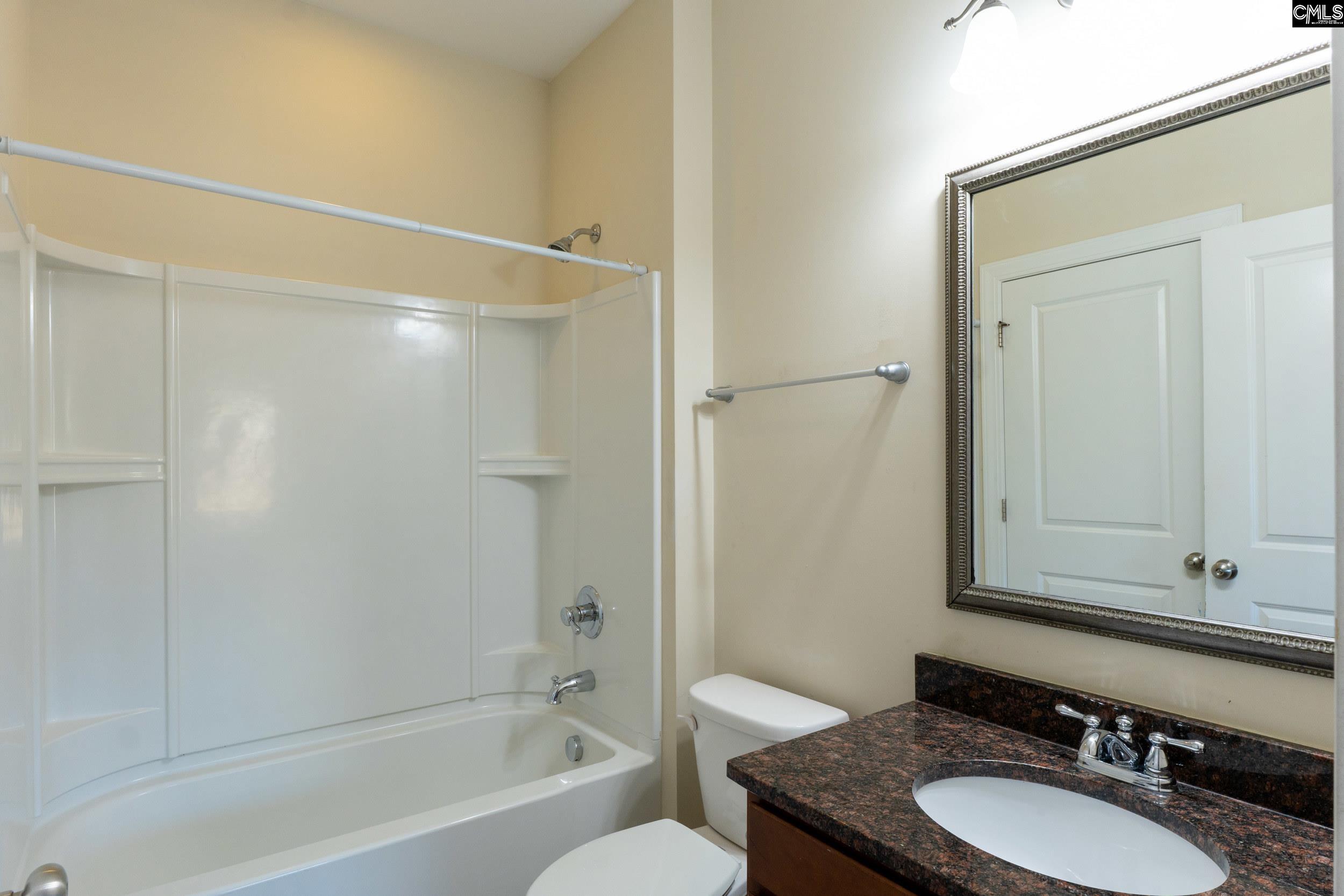 40 Wading Bird Loop Blythewood, SC 29016 - Photo 19 of 26 a bathroom with a granite countertop sink toilet and shower