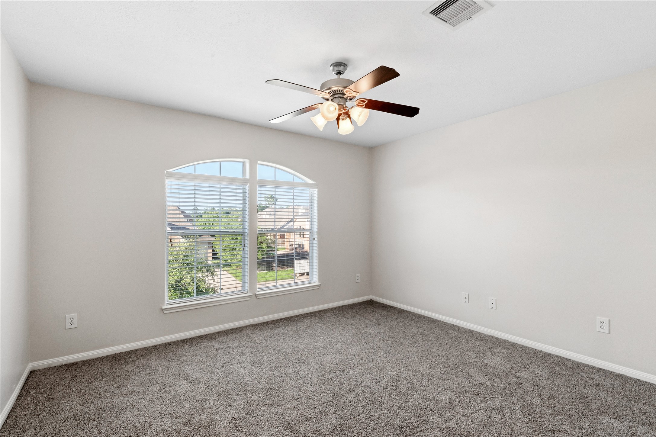 6211 Stone Hill Road Spring, TX 77389 - Photo 37 of 43 an empty room with windows and fan