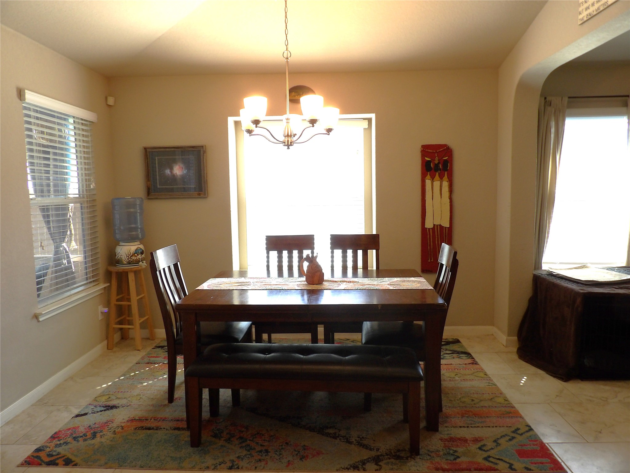 930 Pumpkin Ridge New Braunfels, TX 78130 - Photo 10 of 32 Dining area featuring neutral wall paint, tile flooring, a chandelier, and window treatments