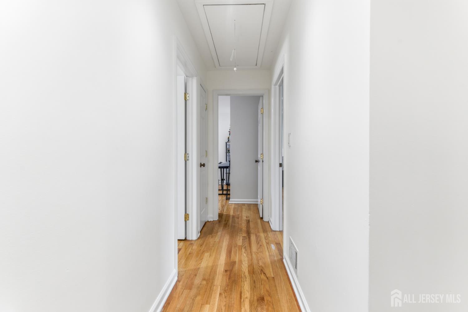 213 Normandy Road Edison, NJ 08820 - Photo 26 of 45 a view of a hallway with wooden floor