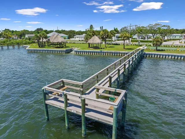 a view of a lake with a table and chairs