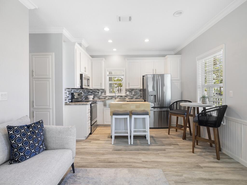 12939 North Indian River Drive, Unit 1 Sebastian, FL 32958 - Photo 13 of 46 a living room with stainless steel appliances kitchen island granite countertop furniture and a couch
