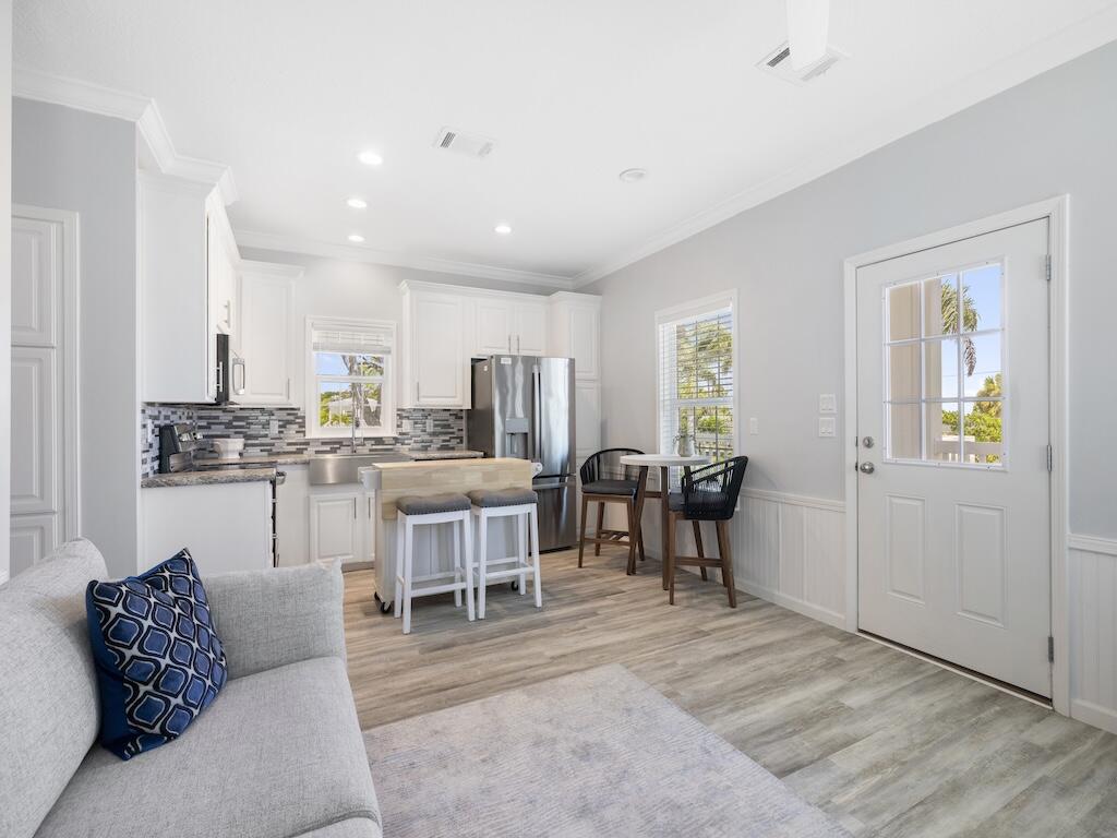 12939 North Indian River Drive, Unit 1 Sebastian, FL 32958 - Photo 14 of 46 a living room with lots of furniture and kitchen view