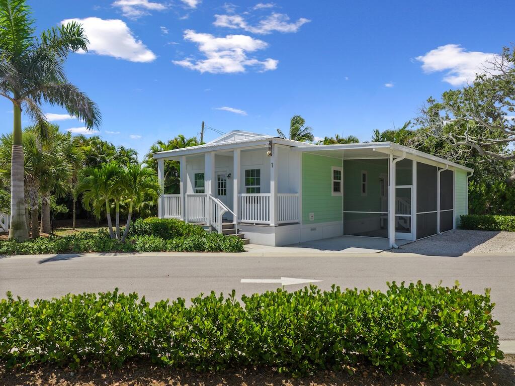 12939 North Indian River Drive, Unit 1 Sebastian, FL 32958 - Photo 2 of 46 a front view of a house with a garden