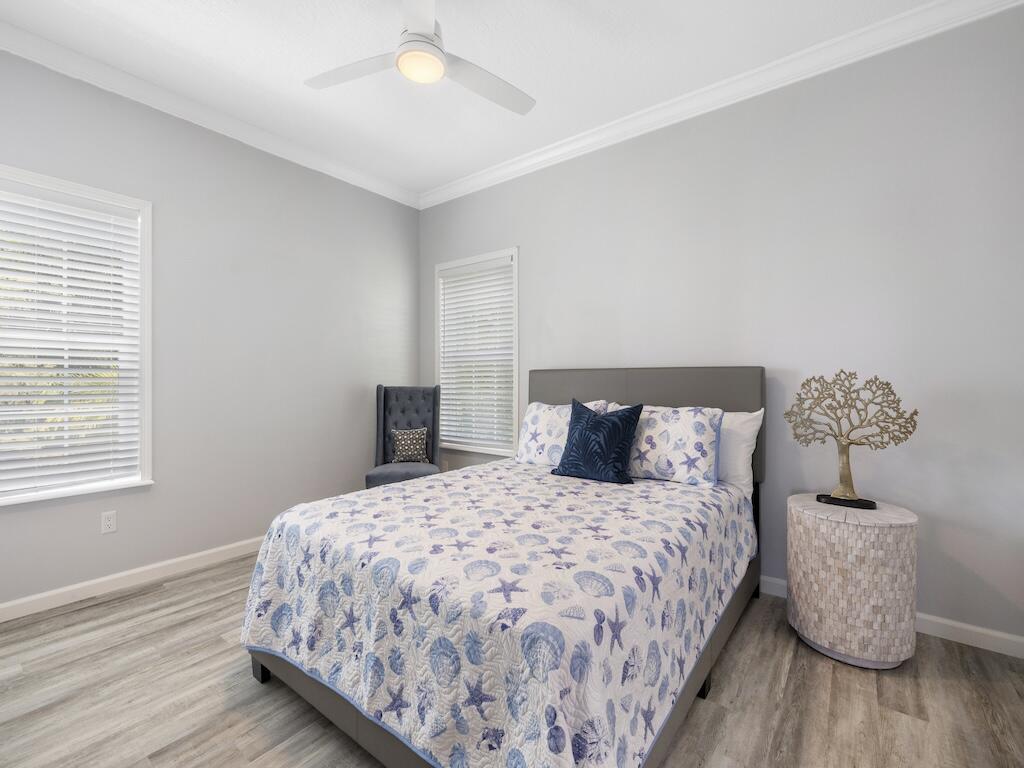 12939 North Indian River Drive, Unit 1 Sebastian, FL 32958 - Photo 21 of 46 a bedroom with a bed and wooden floor