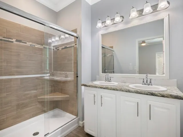 a bathroom with a granite countertop sink mirror and double