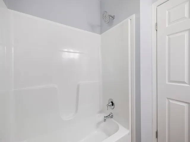 a bathroom with a bathtub and shower