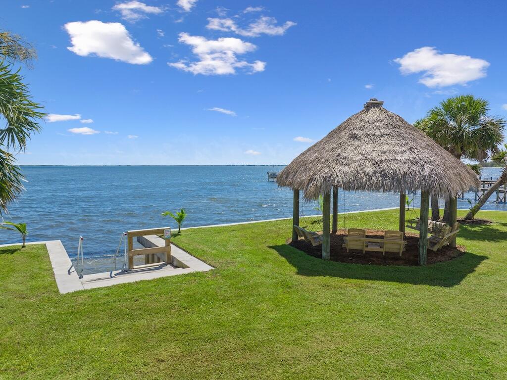 12939 North Indian River Drive, Unit 1 Sebastian, FL 32958 - Photo 37 of 46 a view of a garden with a bench