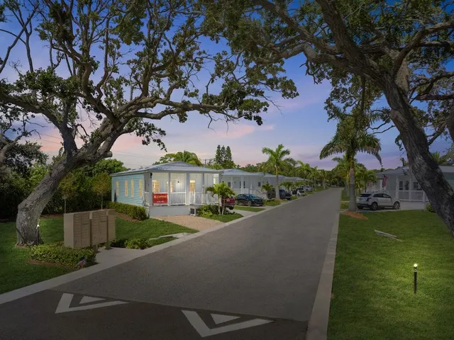 a view of a house with a tree in a yard