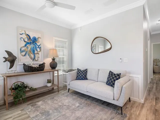 a living room with furniture and wooden floor