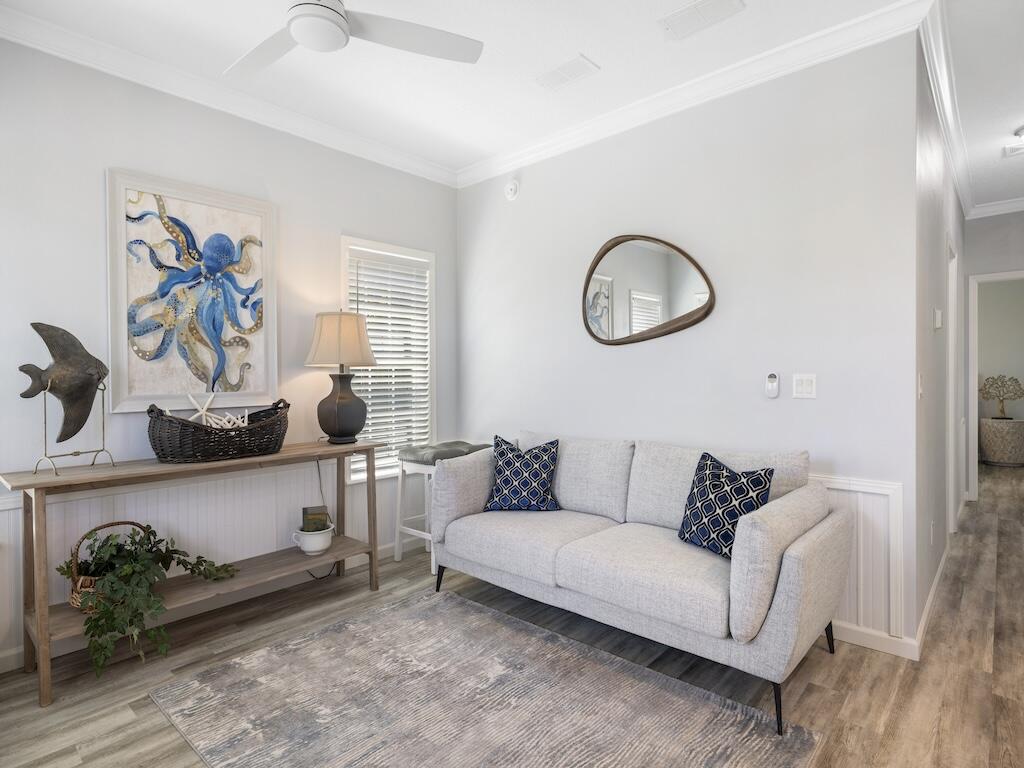 12939 North Indian River Drive, Unit 1 Sebastian, FL 32958 - Photo 5 of 46 a living room with furniture and wooden floor