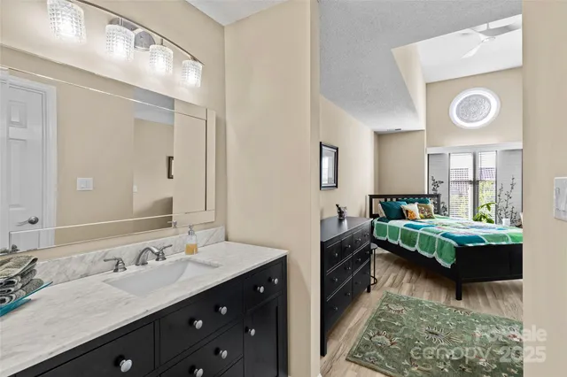 a en suite bathroom with a double vanity sink and a mirror