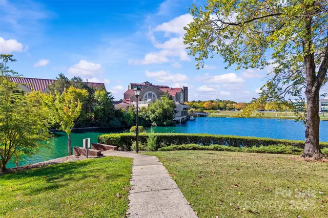 a view of a fountain in front of a house with a big yard