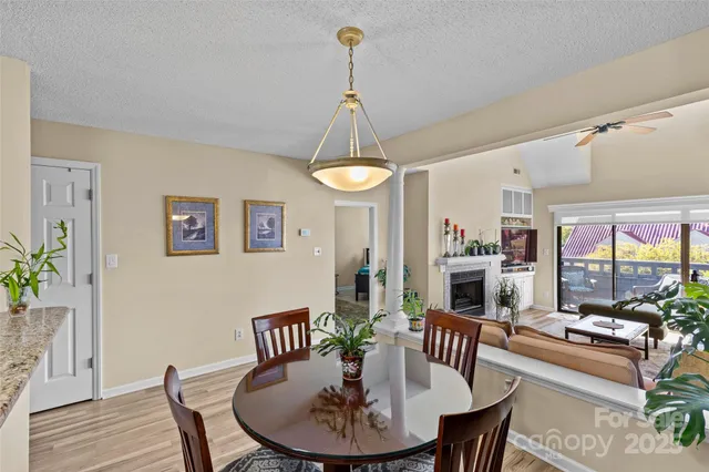 a view of a dining room with furniture wooden floor and chandelier