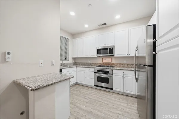 a kitchen with a sink stove and microwave