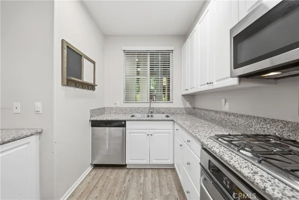 a kitchen with a stove a sink and a microwave
