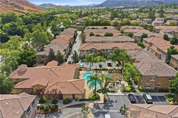 an aerial view of residential houses with outdoor space and street view