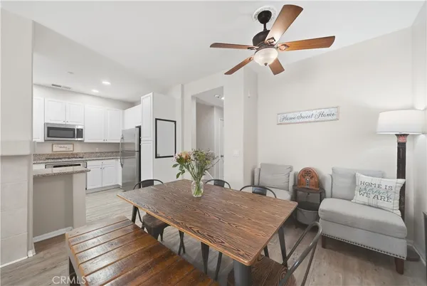 a living room with stainless steel appliances kitchen island granite countertop furniture and a kitchen view
