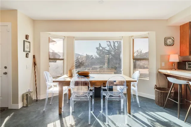 a view of a dining room with furniture window and outside view