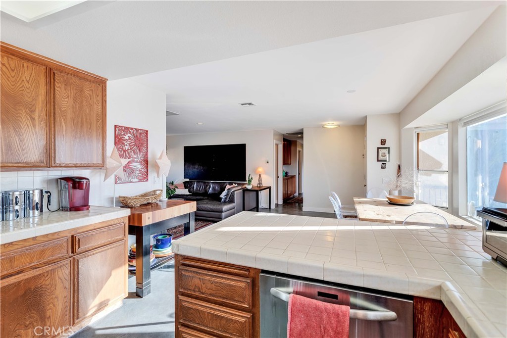 8775 Desert Shadow Road Joshua Tree, CA 92252 - Photo 16 of 39 a room with stainless steel appliances kitchen island granite countertop a sink and cabinets