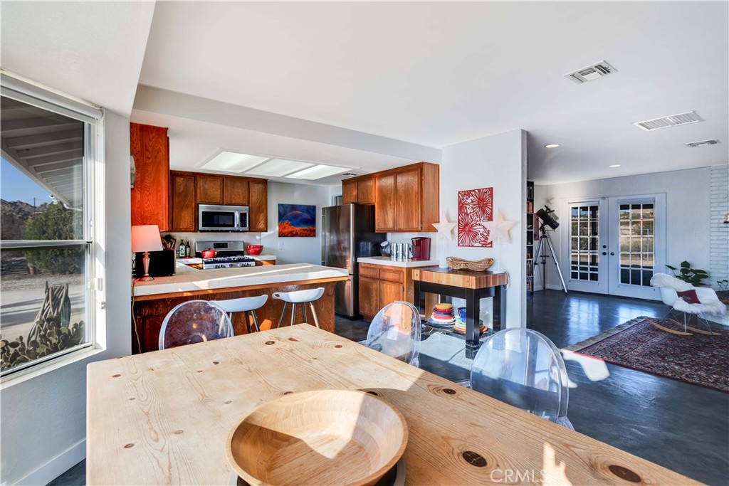 8775 Desert Shadow Road Joshua Tree, CA 92252 - Photo 17 of 39 a living room with fireplace furniture and a wooden floor