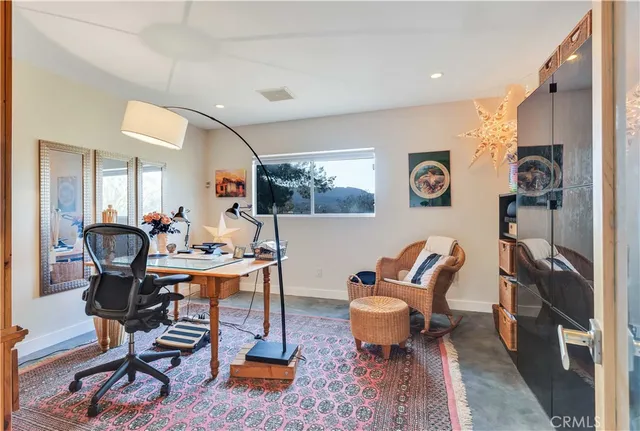 a living room with furniture a rug and a window