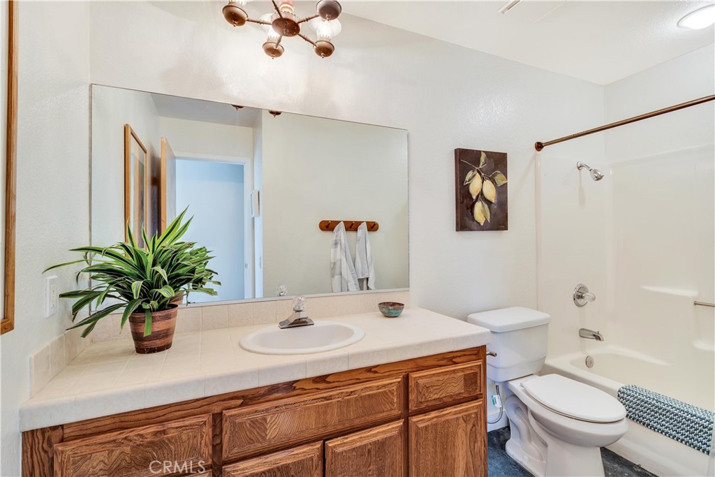 8775 Desert Shadow Road Joshua Tree, CA 92252 - Photo 24 of 39 a bathroom with a sink a toilet and a mirror