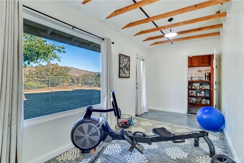 8775 Desert Shadow Road Joshua Tree, CA 92252 - Photo 26 of 39 a room with furniture and a window