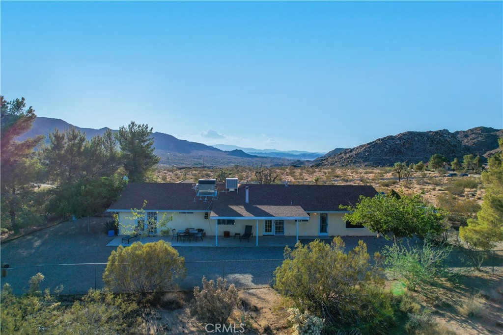 8775 Desert Shadow Road Joshua Tree, CA 92252 - Photo 35 of 39 an aerial view of residential houses with outdoor space and trees