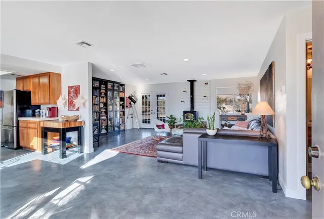 a living room with furniture and a kitchen