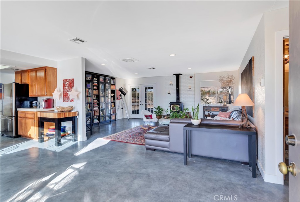8775 Desert Shadow Road Joshua Tree, CA 92252 - Photo 6 of 39 a living room with furniture and a kitchen
