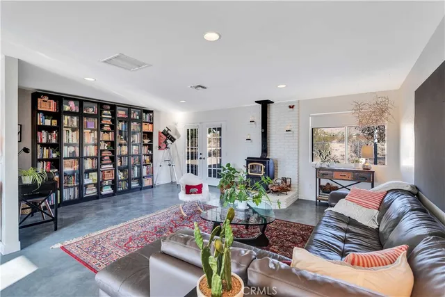 a living room with furniture and book shelf