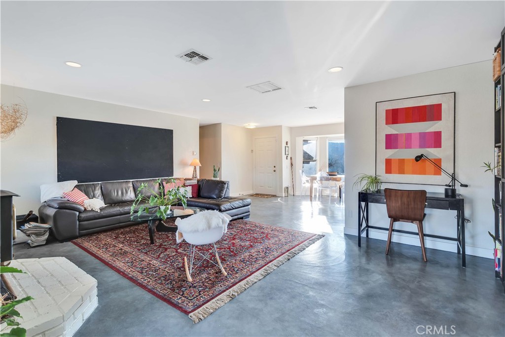 8775 Desert Shadow Road Joshua Tree, CA 92252 - Photo 9 of 39 a living room with furniture a rug and a flat screen tv
