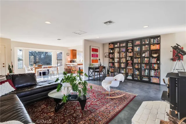 a living room with furniture rug and lamp