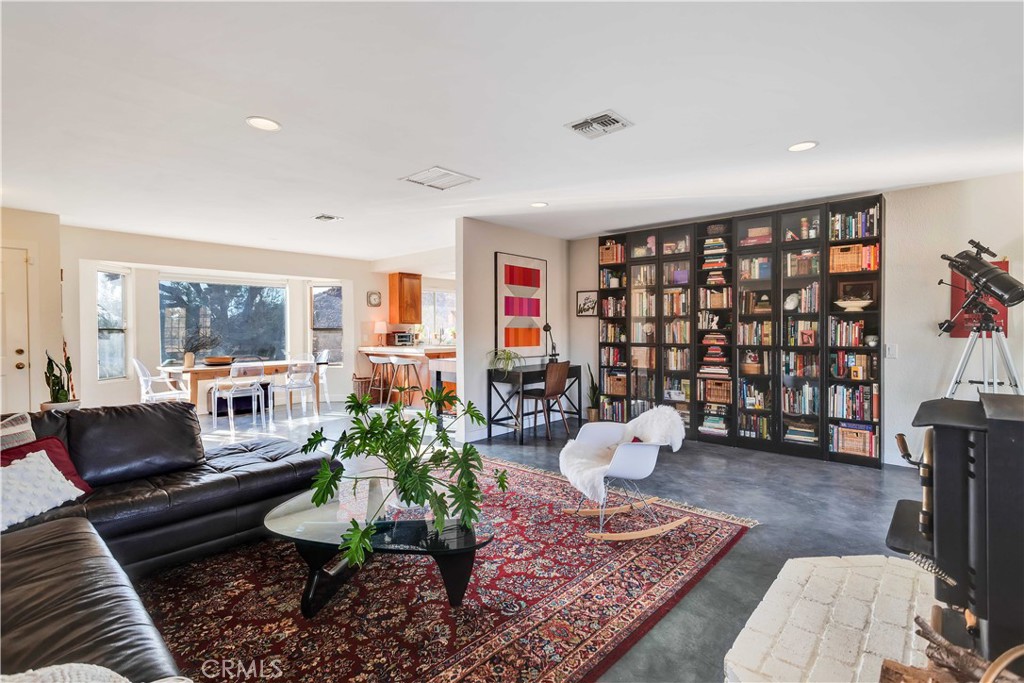 8775 Desert Shadow Road Joshua Tree, CA 92252 - Photo 10 of 39 a living room with furniture rug and lamp