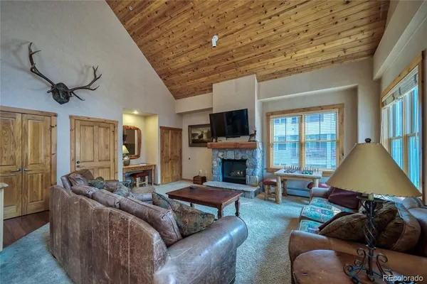 a living room with furniture a fireplace and a flat screen tv