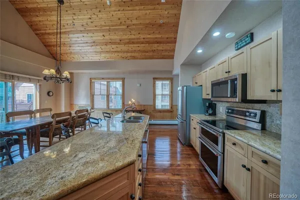a large kitchen with lots of counter space and stainless steel appliances