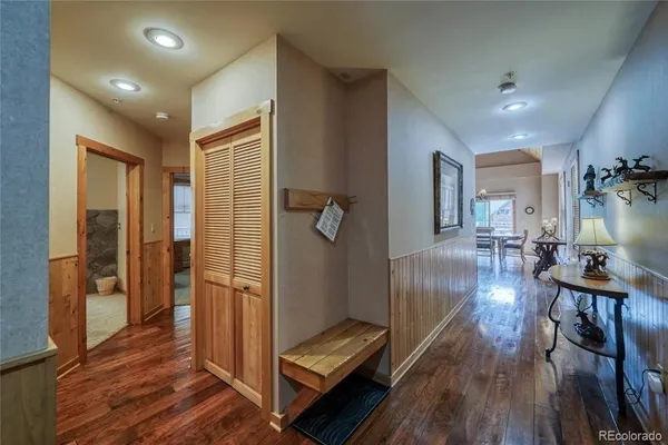a view of hallway with livingroom and wooden floor