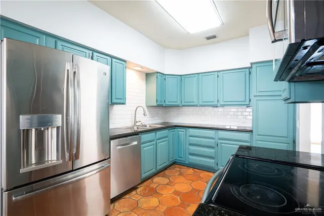 a kitchen with a sink stove and refrigerator