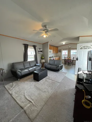 a living room with furniture and a chandelier