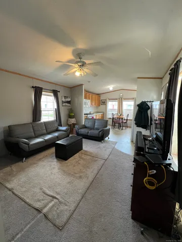 a living room with furniture gym equipment and a flat screen tv